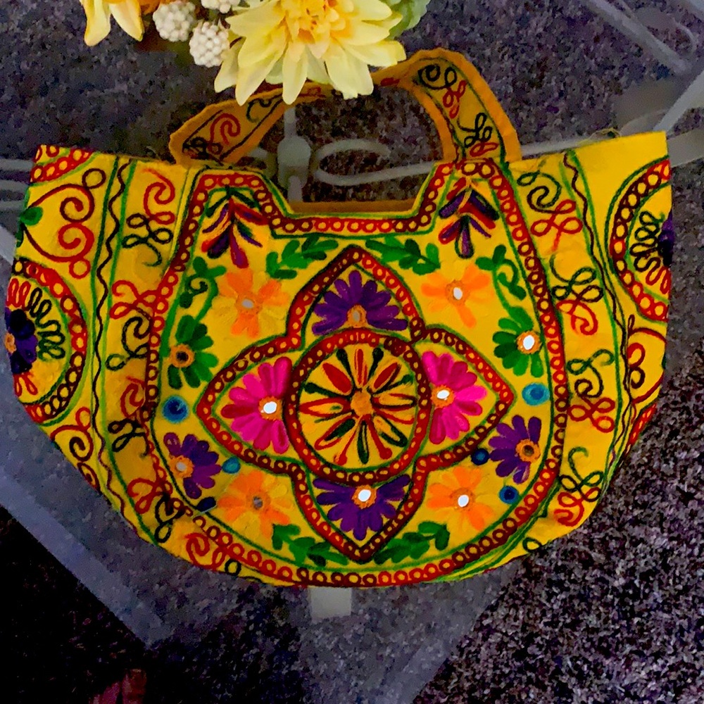 This is a beautiful Indian bag with embroidery and mirrors .